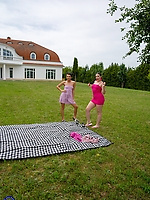 Naked outdoor threesome on picnic blanket with three women in spread pose