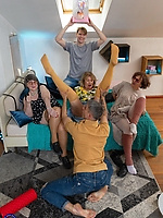 Mature women in colorful thigh-high tights pose together in group