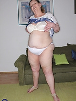 Mature milf solo tease with saggy tits, hairy pussy and legs spread on couch