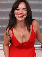 Sultry brunette teasing in red lingerie and heels by the window