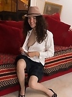 Smiling brunette in hat spreads legs showing very hairy cunt