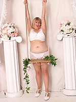 Senior lady poses in bridal lingerie set