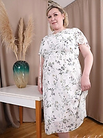 Mature nude woman with bush, saggy tits and curvy belly in bold solo tease