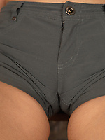 Short-haired blonde stripping in rustic room showing hairy pussy