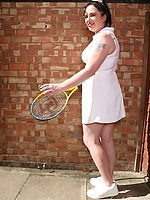 Mature brunette in tennis outfit teasing outdoors