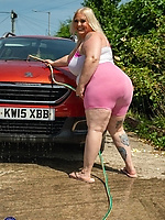Mature milf curvy babe in pink lingerie teases big booty at outdoor car wash