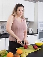 Chubby mature strips down in kitchen and masturbates with banana