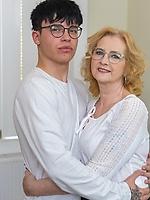 Mature babe in blouse and patterned stockings giving clothed living room tease