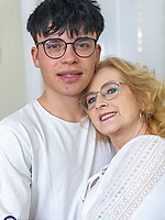 Mature babe in blouse and patterned stockings giving clothed living room tease