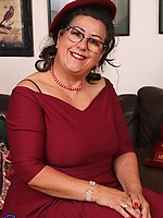 Busty mature strips red dress and lingerie teasing her pussy