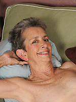 Mature naked granny with natural tits and hairy pussy in a bold spread pose