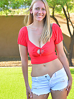 Cute blonde MILF in shorts shows saggy boobs in the backyard