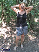 Busty mature flashing tits in forest sunlight