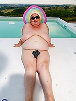 BBW granny flashing hairy pussy in swimsuit