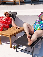 Poolside lesbian pussy licking in pink suit