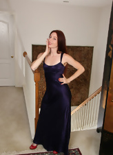 Pale-skinned redhead takes off elegant dress in solo pics