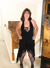 MILF with sexy smile takes off dress, pantyhose and panties