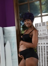 Black pregnant bitch with awesome forms poses in sex photos