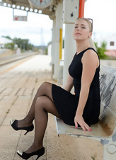 Blonde mom in stockings shows pussy waiting for the train