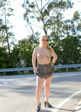 Classy mom walks near road and exposes her round big tits