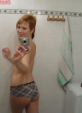 Nice red-haired mom takes nude selfies in the bathroom