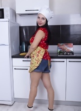 Brunette maid undresses and shows hairy cunt in the kitchen