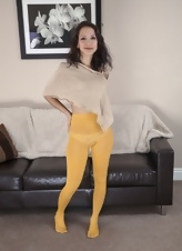 Sexy brunette in yellow pantyhose shows her hairy twat on couch