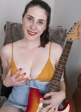 Joyful MILF with juicy tits displays hairy cunny in living room