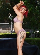 Inked redhead displays her bush outdoors in nude moms pics