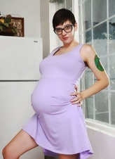 Pregnant MILF with short hair shows her bush in solo pictures