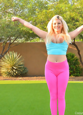 Blonde mom during outdoor fitness finds time for fun with toy