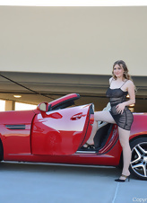 Blonde MILF is posing next to a car and masturbates right after