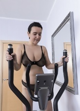 A milf with saggy tits works out on the exercise machine naked