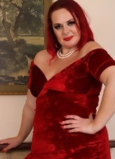 Red-haired mature lady in red dress shows her sagging tits