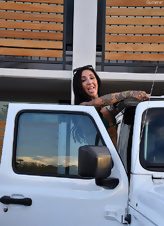 A milf in a sexy bikini takes a lot of porn pics in front of an SUV.