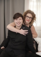 Glasses-wearing mommy is about to take a younger sexy cock