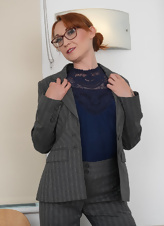 Red haired secretary shows her naked body and small tits