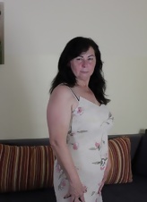 Older Brunette Strips And Teases