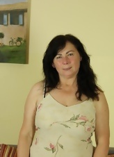 Older Brunette Strips And Teases