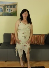 Older Brunette Strips And Teases