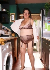 Mature Brunette In Lingerie Kitchen Strip Gallery