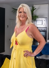 Mature Blonde Teasing Yellow Dress Photos