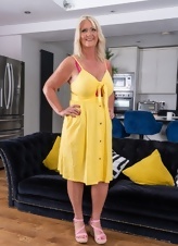 Mature Blonde Teasing Yellow Dress Photos