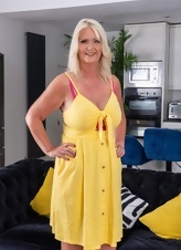 Mature Blonde Teasing Yellow Dress Photos